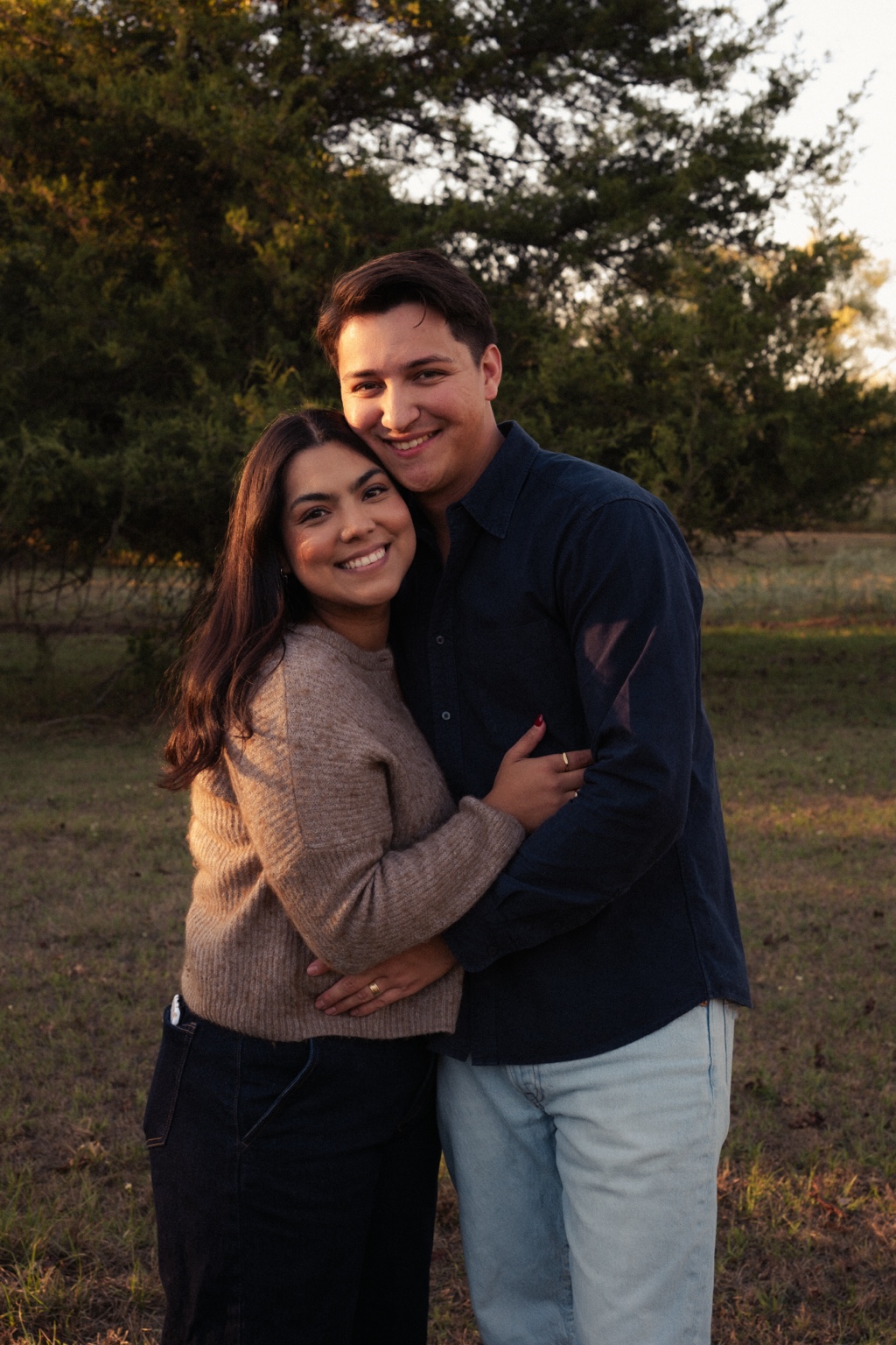A couple embracing outdoors in the evening sun