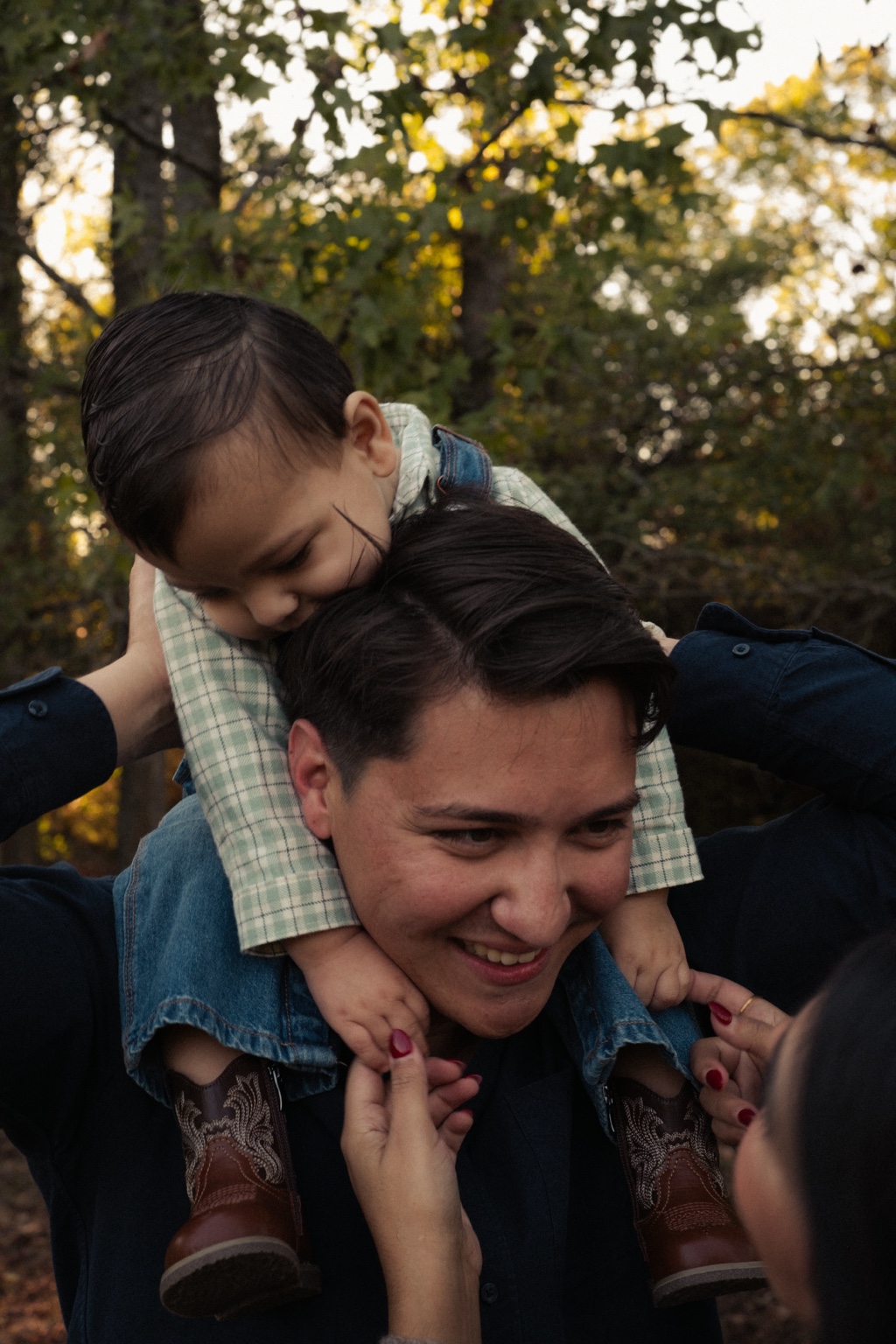 A child riding on his father’s shoulders